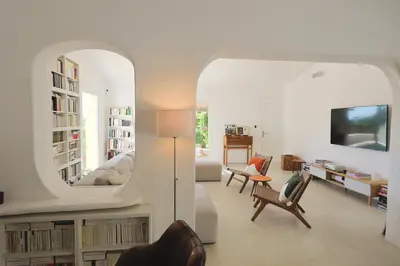 a living room with a large mirror and a couch at Villa Luma, 3 Chambres avec Piscine Chauffée in Figari