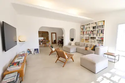 a white living room with a couch and a table at Villa Luma, 3 Chambres avec Piscine Chauffée in Figari
