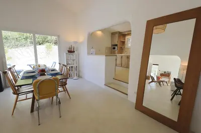 a dining room and kitchen with a table and chairs at Villa Luma, 3 Chambres avec Piscine Chauffée in Figari