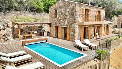 a patio with a swimming pool and a house at Bergerie de charme, piscine chauffée, vue nature entre mer et montagne, Sotta in Sotta