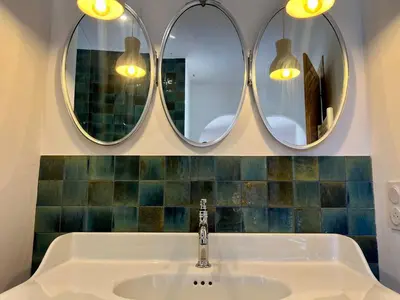 a bathroom with two mirrors above a sink at Bergerie de charme, piscine chauffée, vue nature entre mer et montagne, Sotta in Sotta