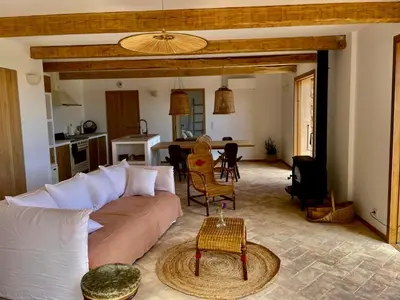 a living room with a couch and a table at Bergerie de charme, piscine chauffée, vue nature entre mer et montagne, Sotta in Sotta