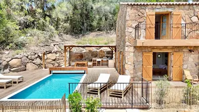 a villa with a swimming pool and a house at Bergerie de charme, piscine chauffée, vue nature entre mer et montagne, Sotta in Sotta