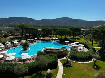 a dining room with a table and chairs on a patio at Appartement dans résidence standing in Porto-Vecchio