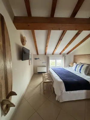 a bedroom with a large bed and a tv at Appartement dans résidence standing in Porto-Vecchio