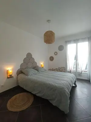 a bedroom with a large bed in a room at Jolie location chez Philippe & Karine in Linguizzetta