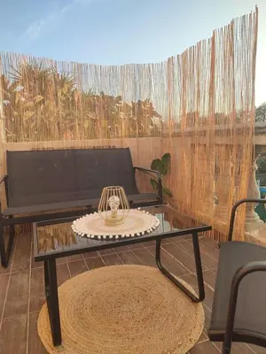 a coffee table on a patio with a couch at Jolie location chez Philippe & Karine in Linguizzetta