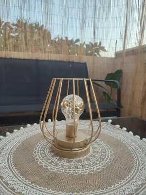 a lamp sitting on top of a table at Jolie location chez Philippe & Karine in Linguizzetta