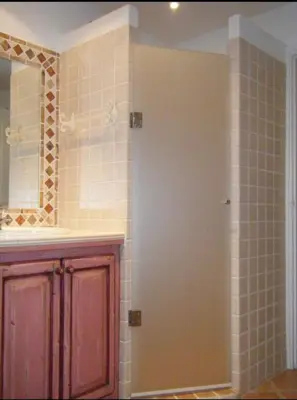 a bathroom with a shower and a mirror at Villa Ysee in Porto-Vecchio