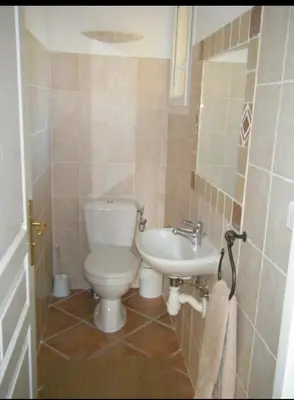 a bathroom with a toilet and a sink at Villa Ysee in Porto-Vecchio