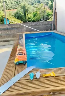 a toy car sitting next to a swimming pool at Belle maison en Balagne in Zilia