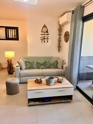 a living room with a couch and a coffee table at Appartement A Maghjina proche port et centre ville in Porto-Vecchio