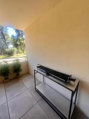 a black piano sitting in a room with a window at Appartement A Maghjina proche port et centre ville in Porto-Vecchio