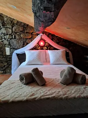 a bed with two stuffed animals on top of it at Maison avec spa aux portes d'Ajaccio in Carbuccia