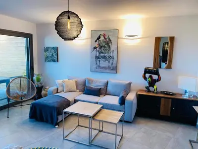 a living room with a couch and a table at Appartement 74 cita Di sali in Porto-Vecchio