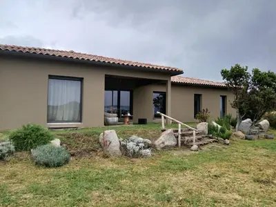 a house with rocks in front of it at Nouveau villa T4 à Sotta entre mer et montagnes in Sotta