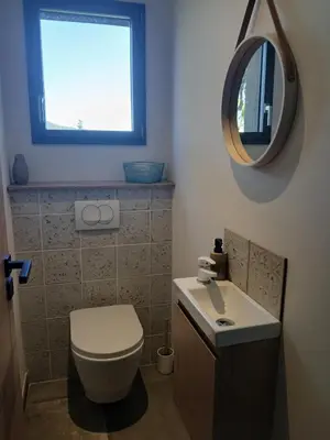 a bathroom with a white toilet and a mirror at Nouveau villa T4 à Sotta entre mer et montagnes in Sotta