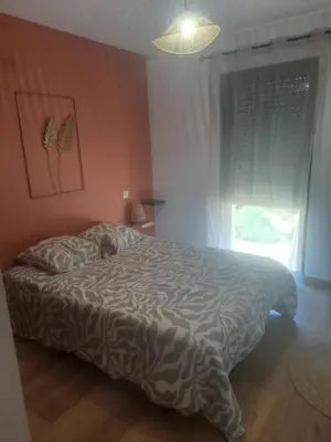 a bedroom with a bed with a cat sleeping on it at Nouveau villa T4 à Sotta entre mer et montagnes in Sotta