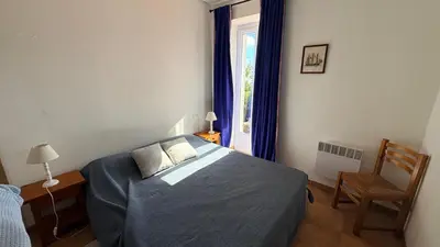a bedroom with a bed and a window at Maison de charme avec vue imprenable sur le golfe de Porto-Vecchio in Porto-Vecchio