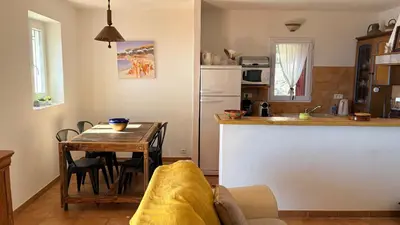 a kitchen with a table and a kitchen with a tableablish at Maison de charme avec vue imprenable sur le golfe de Porto-Vecchio in Porto-Vecchio
