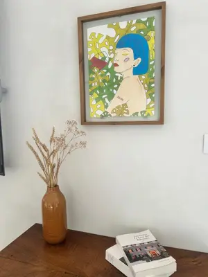 a painting of a woman in a vase on a table at Appartement vue mer Vulpaghja 01 in Cargèse