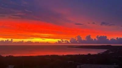 a sunset over a body of water with at Appartement vue mer Vulpaghja 01 in Cargèse