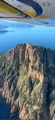 an aerial view of a mountain in the ocean at Appartement vue mer Vulpaghja 01 in Cargèse