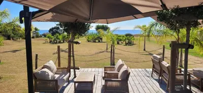 a patio with a table and chairs and an umbrella at Casa Giul' Poggio Mezzana in Poggio-Mezzana