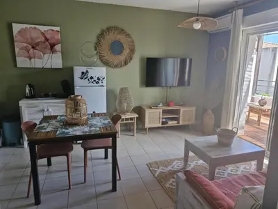 a living room with a table and a tv at Casa Giul' Poggio Mezzana in Poggio-Mezzana