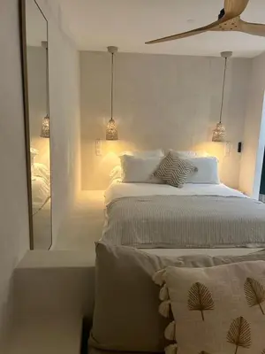 a bedroom with a large bed and a mirror at Appartement vue mer Volpaghja 02 in Cargèse