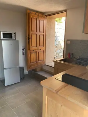 a kitchen with a white refrigerator and a sink at Bella Vista in SantʼAntonino