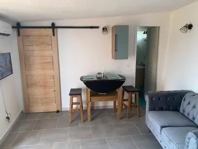 a living room with a couch and a table with a sink at Bella Vista in SantʼAntonino