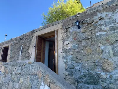 a stone wall with a door on it at Bella Vista in SantʼAntonino