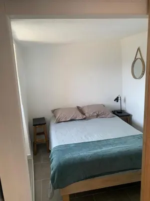 a bedroom with a bed in a white room at Bella Vista in SantʼAntonino