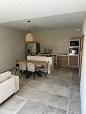 a kitchen and dining room with a table and chairs at Rez-de-villa 65m2 in Propriano