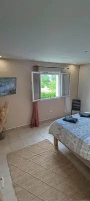 a bedroom with a bed and a window at villa Lucciana in Lucciana