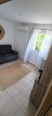 a living room with a couch and a window at villa Lucciana in Lucciana