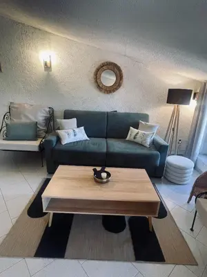 a living room with a blue couch and a coffee table at Puntabe in Lama