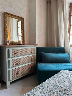 a bedroom with a dresser and a mirror at Puntabe in Lama