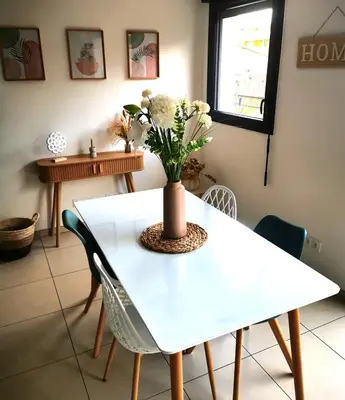 a living room with a couch and a flat screen tv at Appartement T2 à Porto-Vecchio in Porto-Vecchio