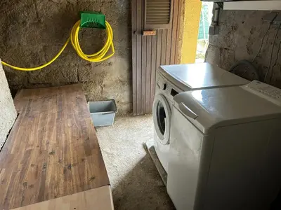 a washing machine in a kitchen with a yellow hose at Appartement avec balcon à Marignana, 30 m², 4 pers. in Marignana