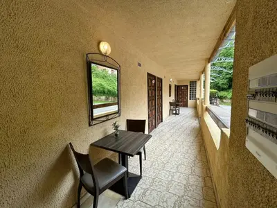 a hallway with a table and chairs and a window at Appartement avec balcon à Marignana, 30 m², 4 pers. in Marignana