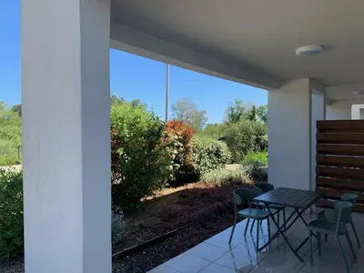 a patio with a table and chairs and a view at Appartement T2 bord de mer N165 in Linguizzetta