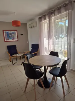 a room with a table and chairs and a window at hjpp in Poggio-Mezzana