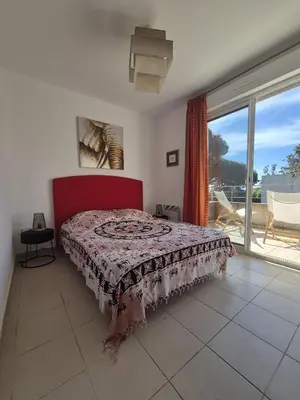 a bedroom with a bed and a large window at hjpp in Poggio-Mezzana