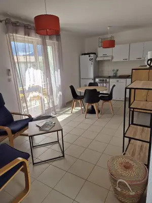 a kitchen and living room with a table and chairs at hjpp in Poggio-Mezzana