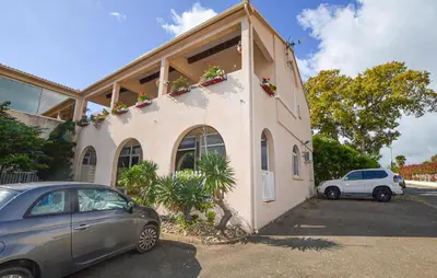 a building with a car parked in front of it at Appartement Residence Piscine in Prunete