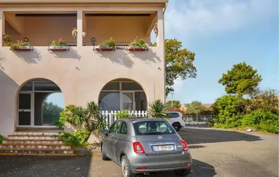 a car parked in front of a house at Appartement Residence Piscine in Prunete