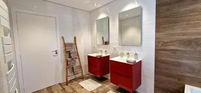 a bathroom with two sinks and a red cabinet at Villa moderne avec piscine 4 étoiles in Sotta