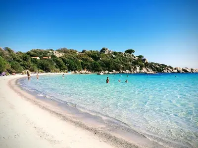 a group of people in the water on a beach at Villa moderne avec piscine 4 étoiles in Sotta
